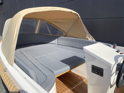 Zonnedek van Marinaut 590 met grijze kussens onder beige cabriokap